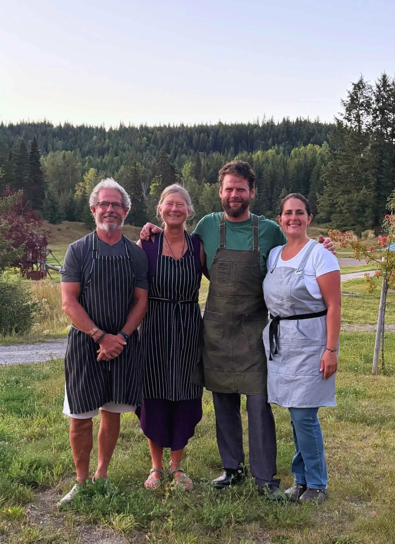The four people who run Kayanara, standing together on the land.