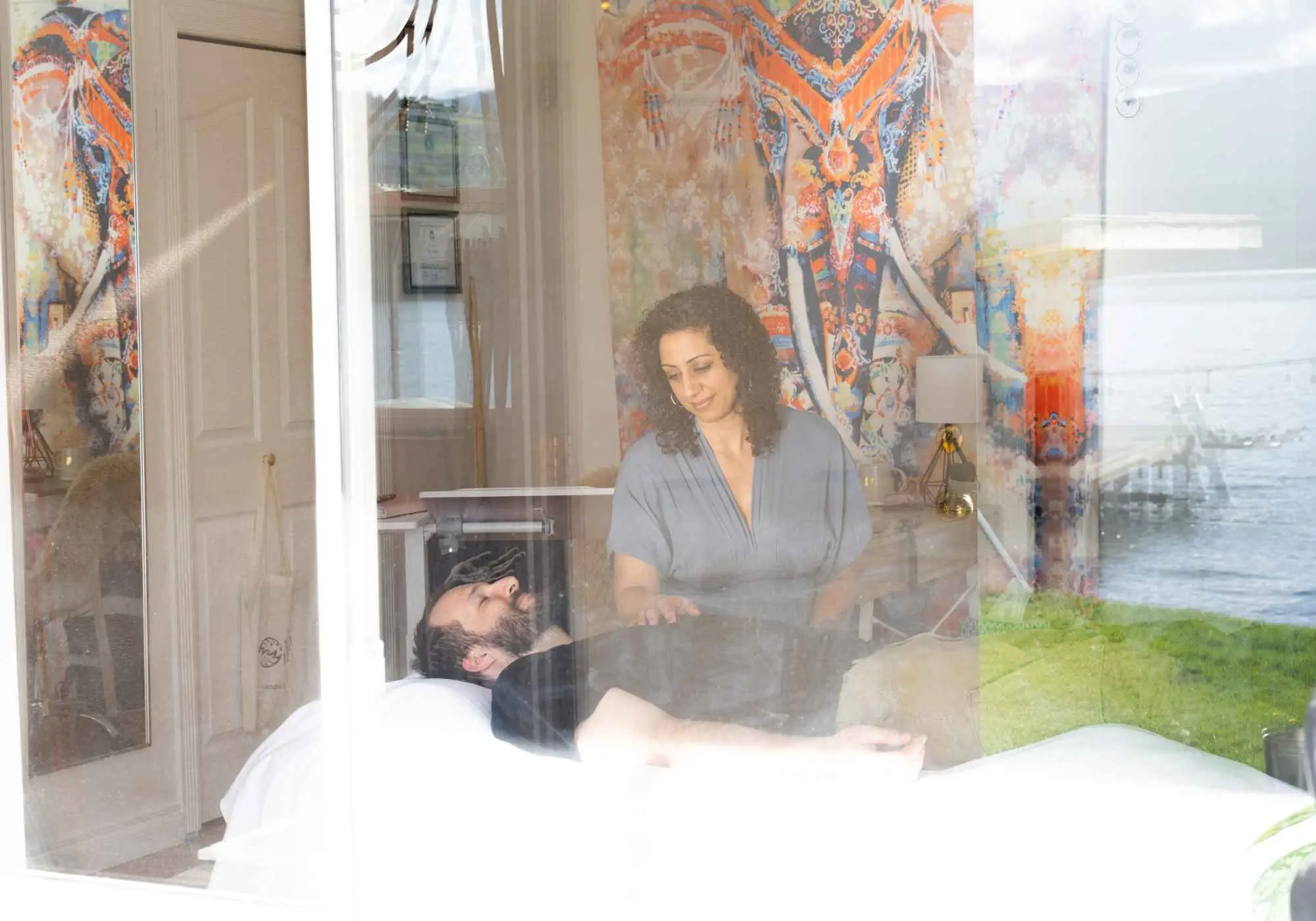 A layered image of Pam Dhillon working with her hands, overlaid with the land and water.